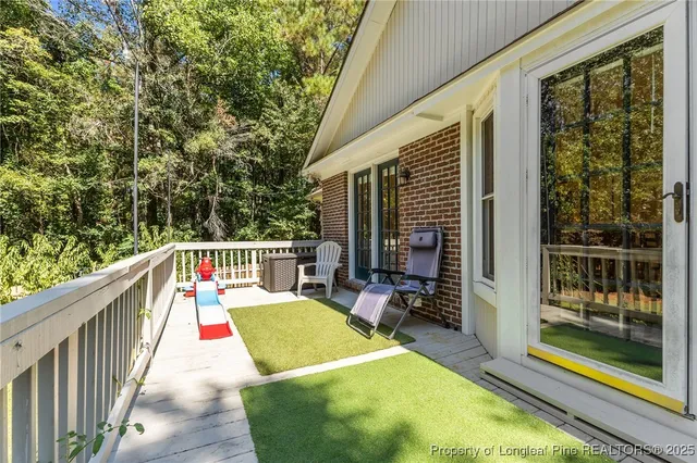 a balcony with chairs and a table