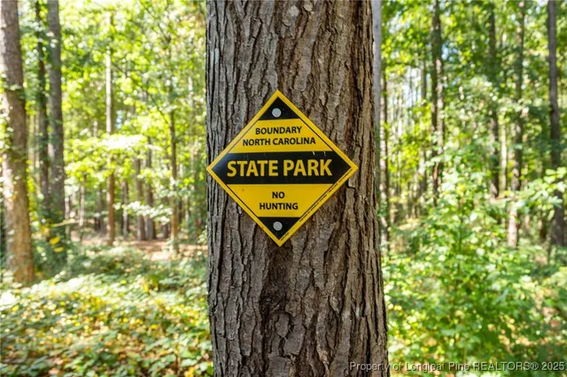 a sign that is on the side of a tree