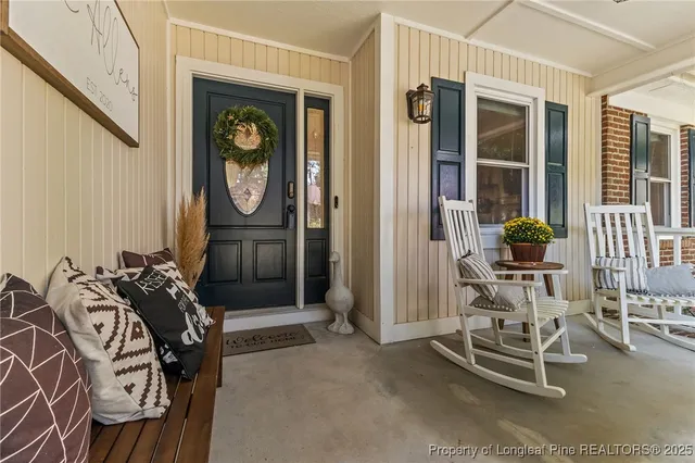 a front view of a house with outdoor seating