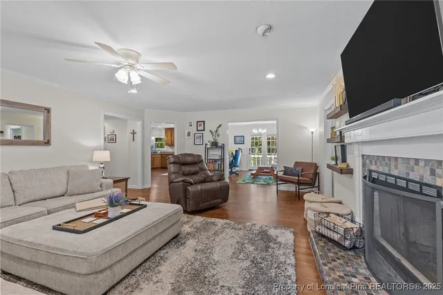 a living room with furniture a fireplace and a flat screen tv