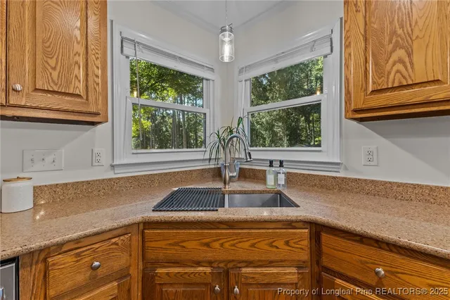 a kitchen with stainless steel appliances granite countertop a sink and a window