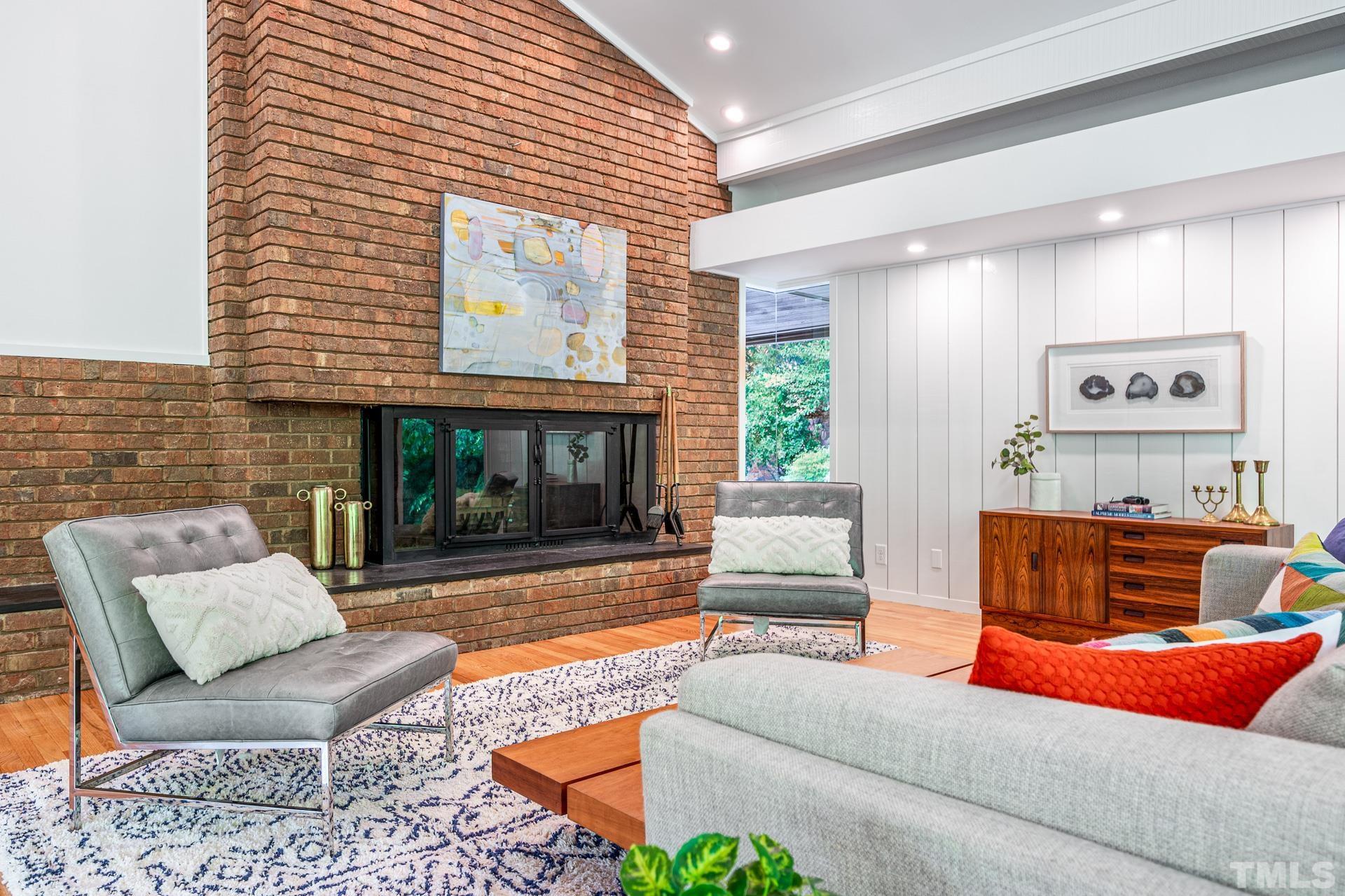 803 Cedar Falls Road Chapel Hill, NC 27514 - Photo 19 of 61 a living room with furniture a flat screen tv and a fireplace