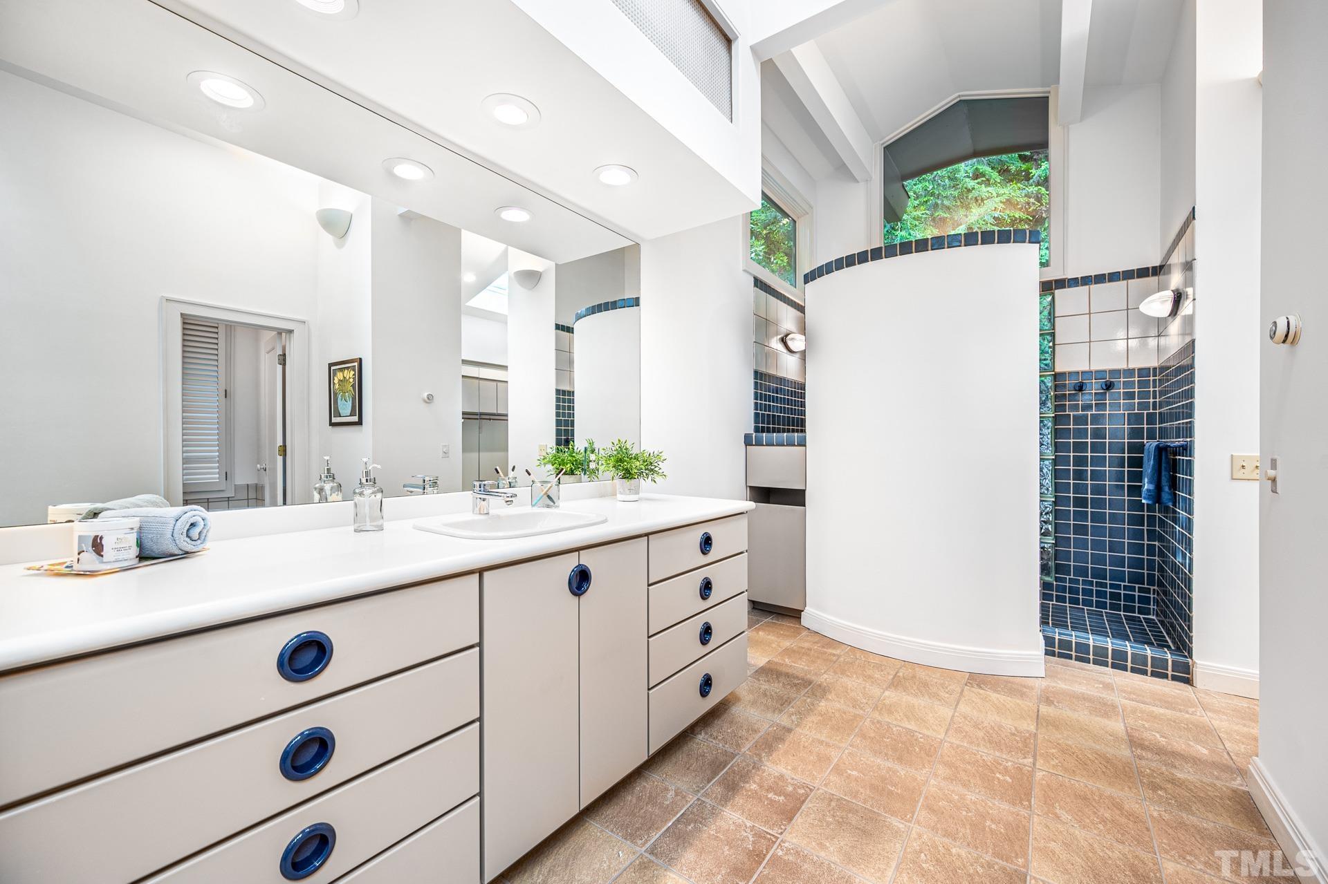 803 Cedar Falls Road Chapel Hill, NC 27514 - Photo 29 of 61 a bathroom with a double vanity sink and mirror