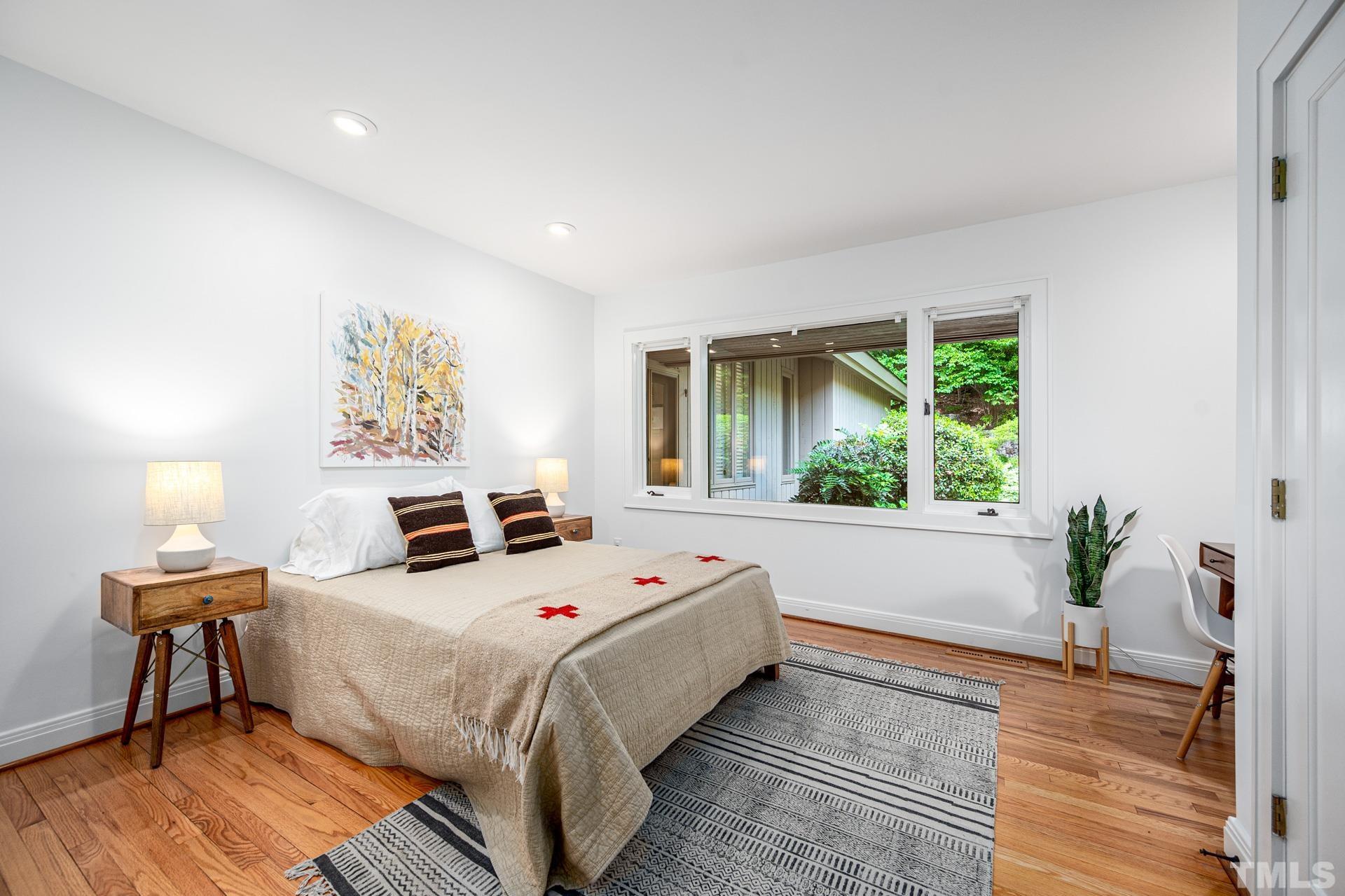 803 Cedar Falls Road Chapel Hill, NC 27514 - Photo 40 of 61 a bed sitting in a spacious bedroom next to a window