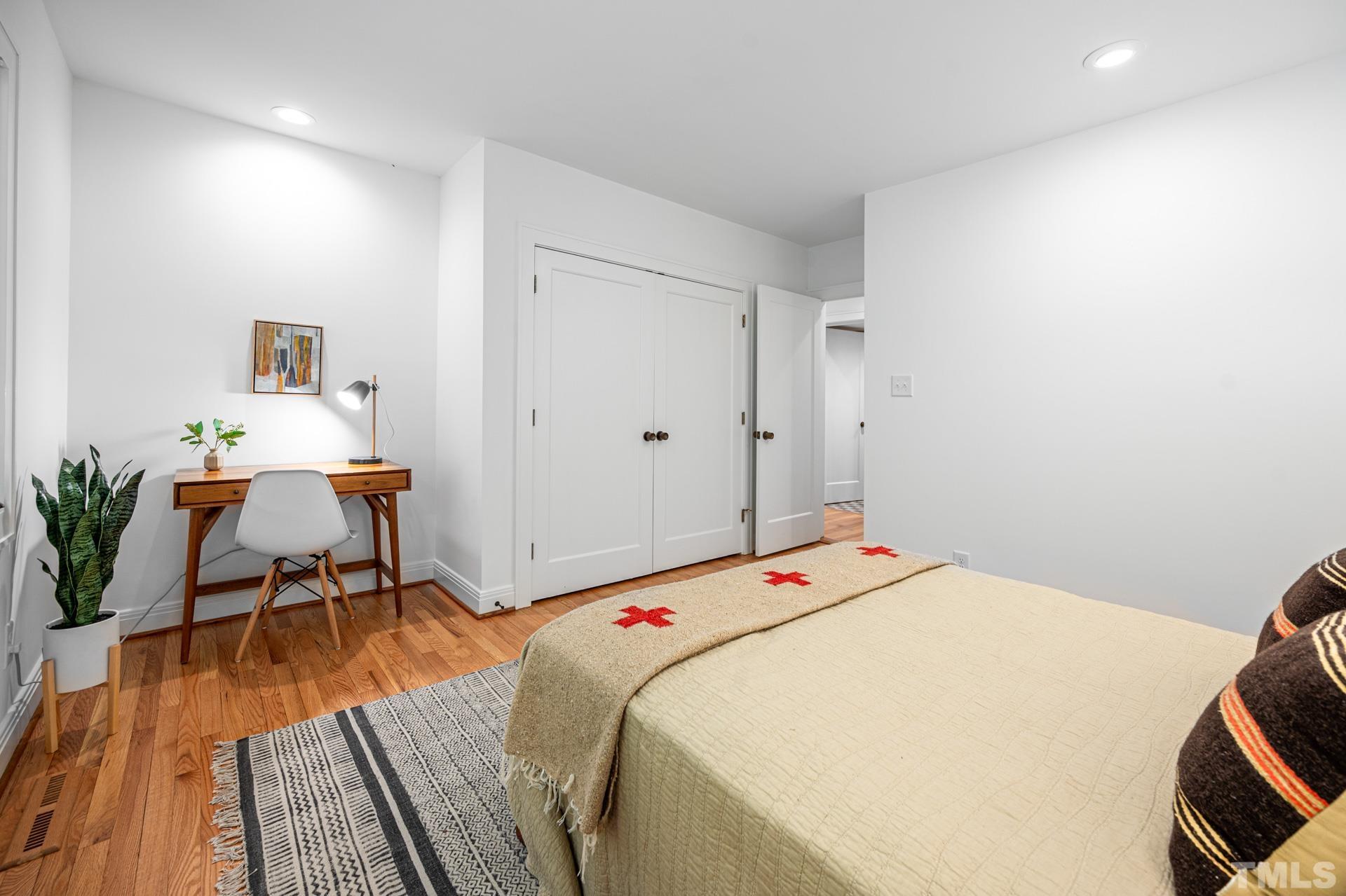 803 Cedar Falls Road Chapel Hill, NC 27514 - Photo 41 of 61 a bedroom with a bed and a table in it