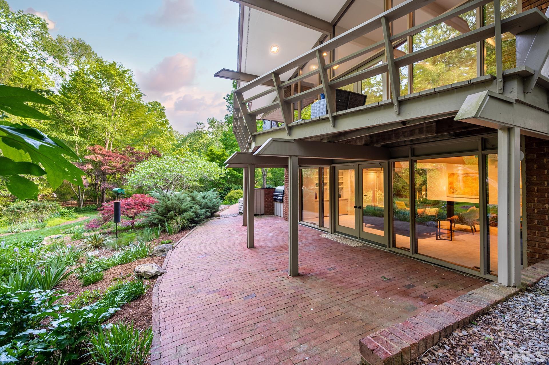 803 Cedar Falls Road Chapel Hill, NC 27514 - Photo 45 of 61 a view of a porch with a table and chairs