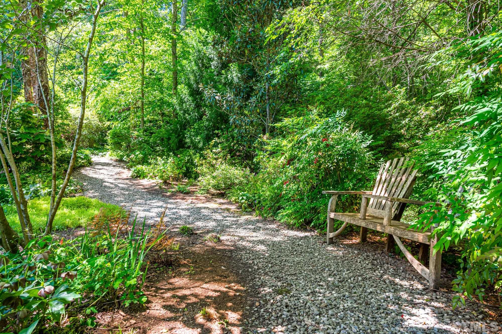 803 Cedar Falls Road Chapel Hill, NC 27514 - Photo 50 of 61 a view of a backyard with chairs and a garden
