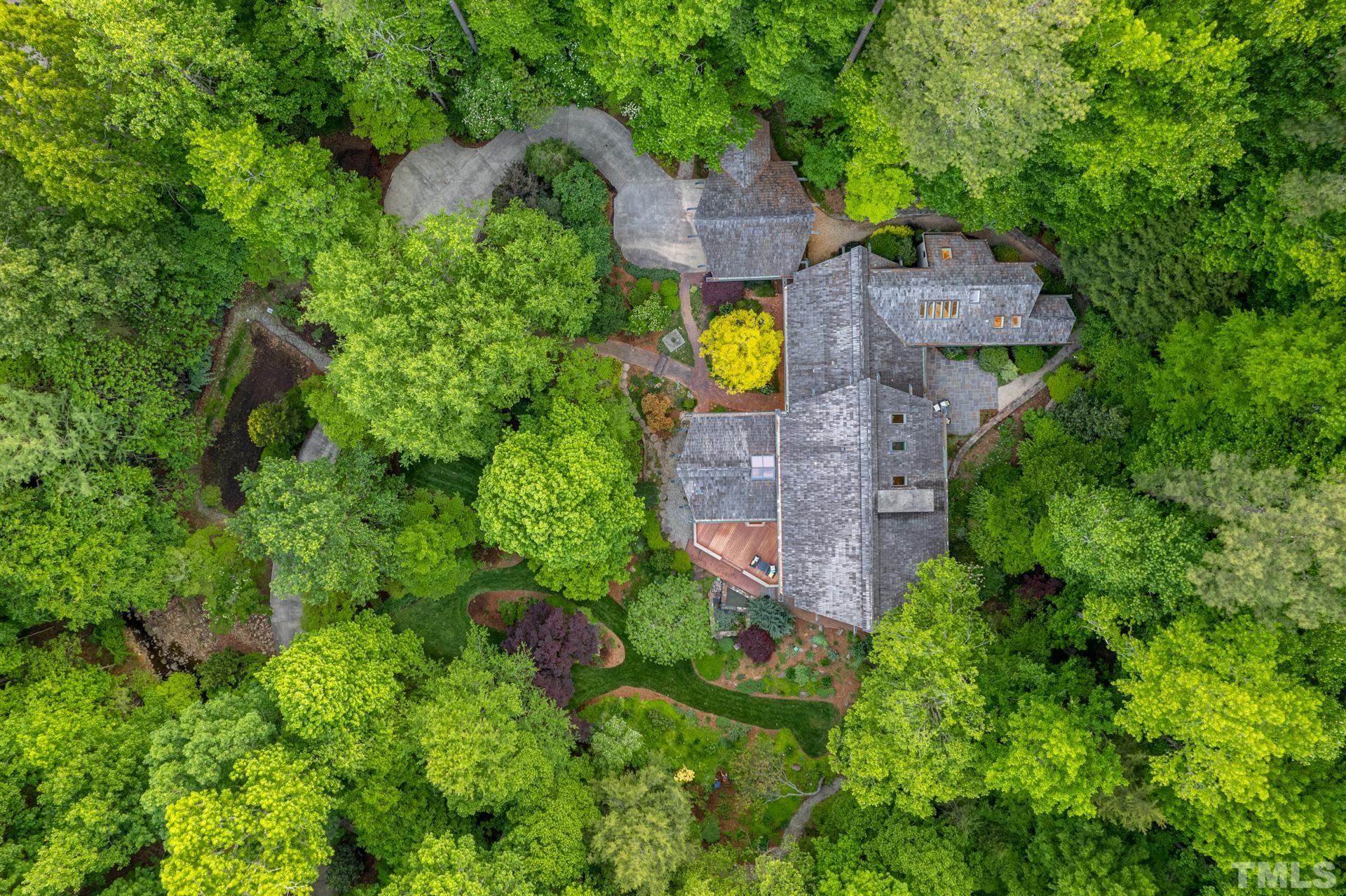 803 Cedar Falls Road Chapel Hill, NC 27514 - Photo 59 of 61 an aerial view of a house with a garden and large trees