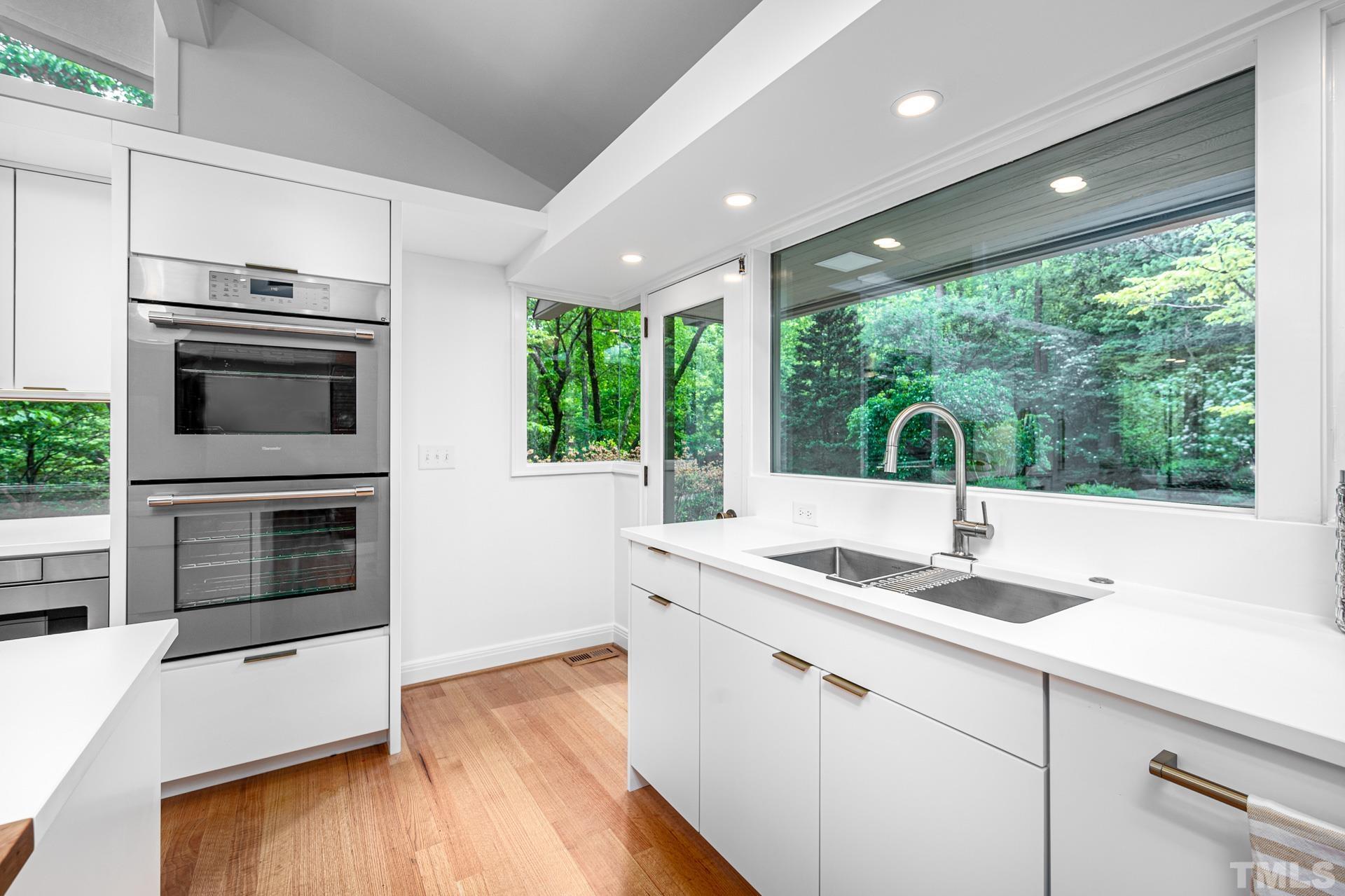 803 Cedar Falls Road Chapel Hill, NC 27514 - Photo 10 of 61 a kitchen with kitchen island granite countertop a sink and stove top oven