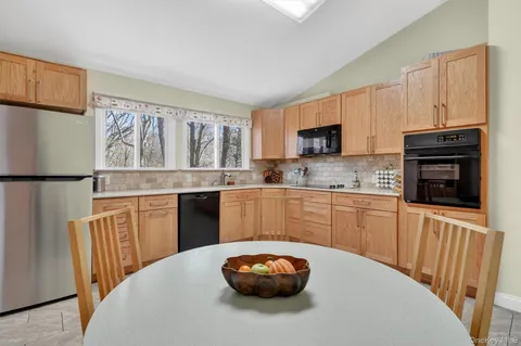a kitchen with stainless steel appliances granite countertop a refrigerator sink microwave and stove