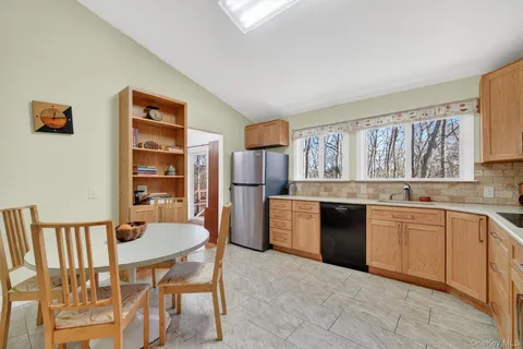 a kitchen with stainless steel appliances granite countertop a kitchen island hardwood floor sink and stove