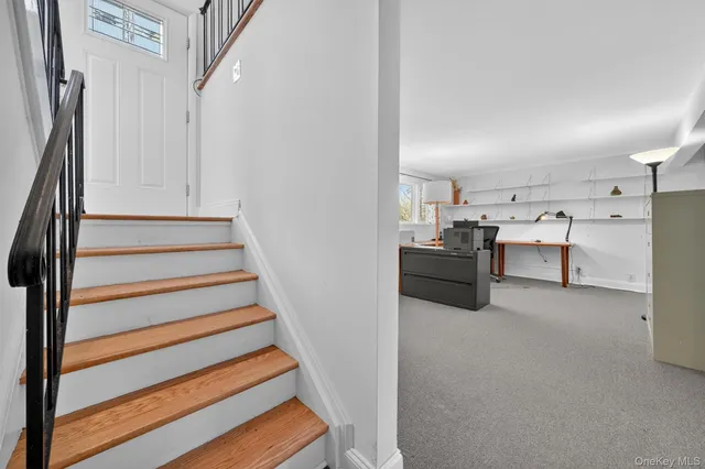 a view of a workspace with furniture and a window