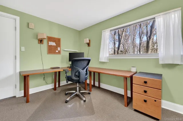 a view of a livingroom with furniture and window