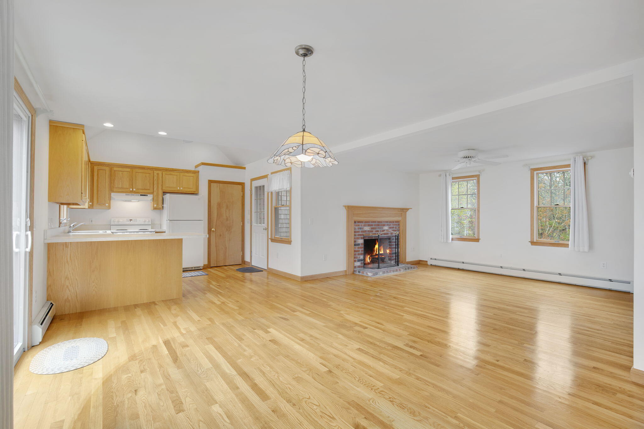 65 Whitney Road Eastham, MA 02642 - Photo 18 of 41 a view of a kitchen with a sink and a fireplace