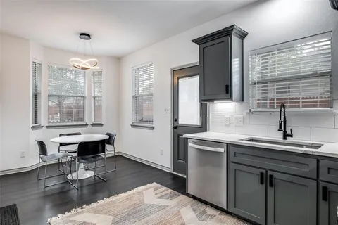 a kitchen with a sink cabinets and wooden floor
