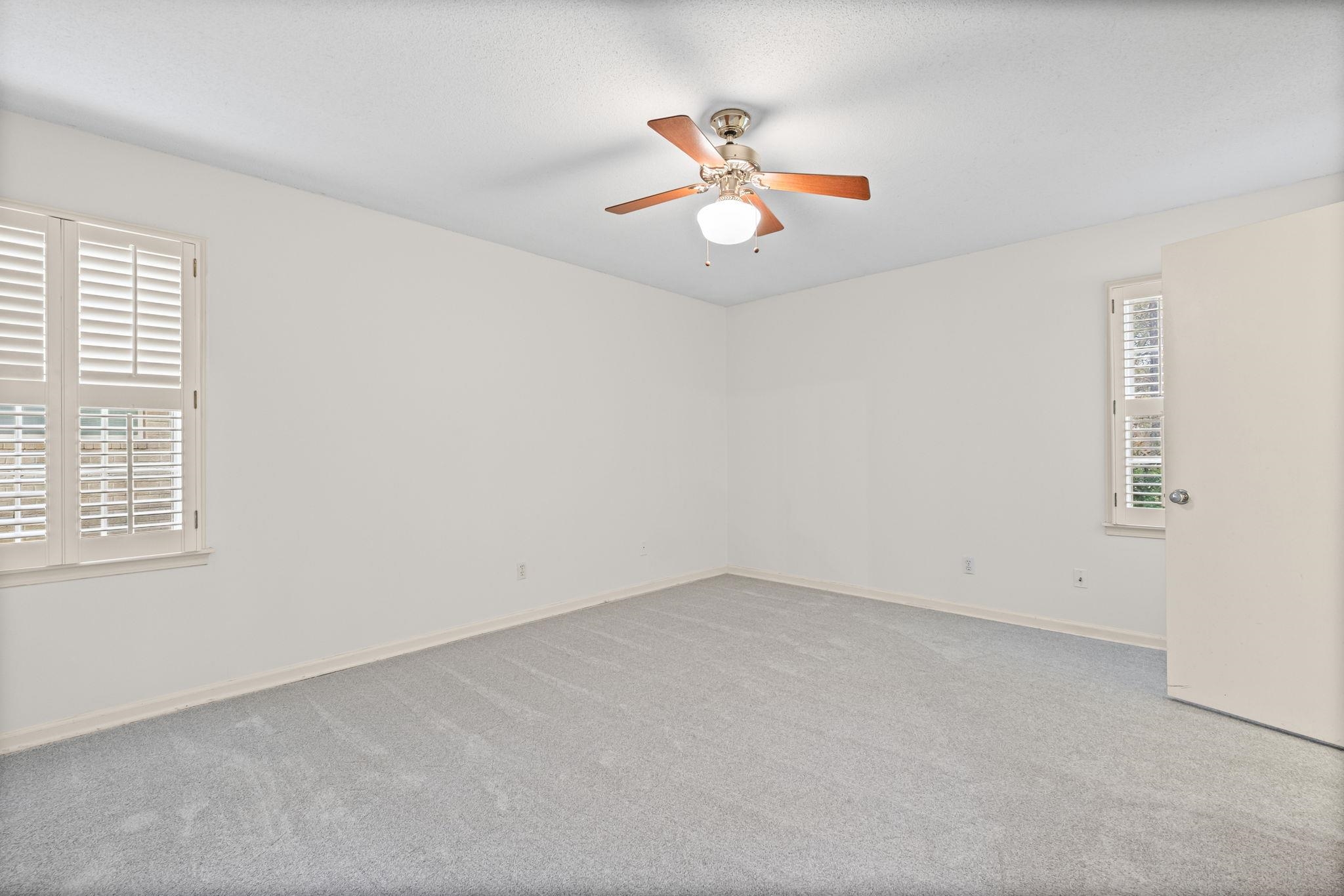 2432 Hawkhurst Street Memphis, TN 38119 - Photo 17 of 31 an empty room with a window and ceiling fan