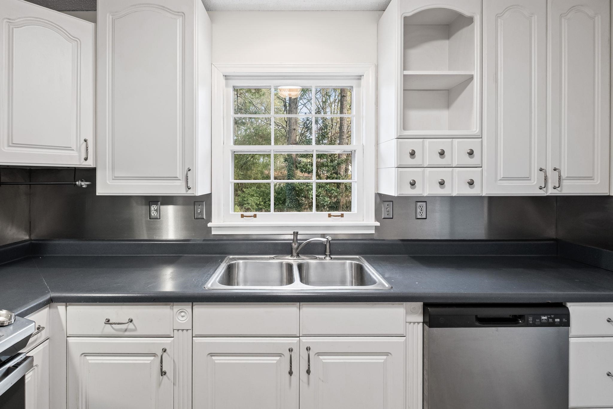 2432 Hawkhurst Street Memphis, TN 38119 - Photo 9 of 31 a kitchen with stainless steel appliances white cabinets and a sink