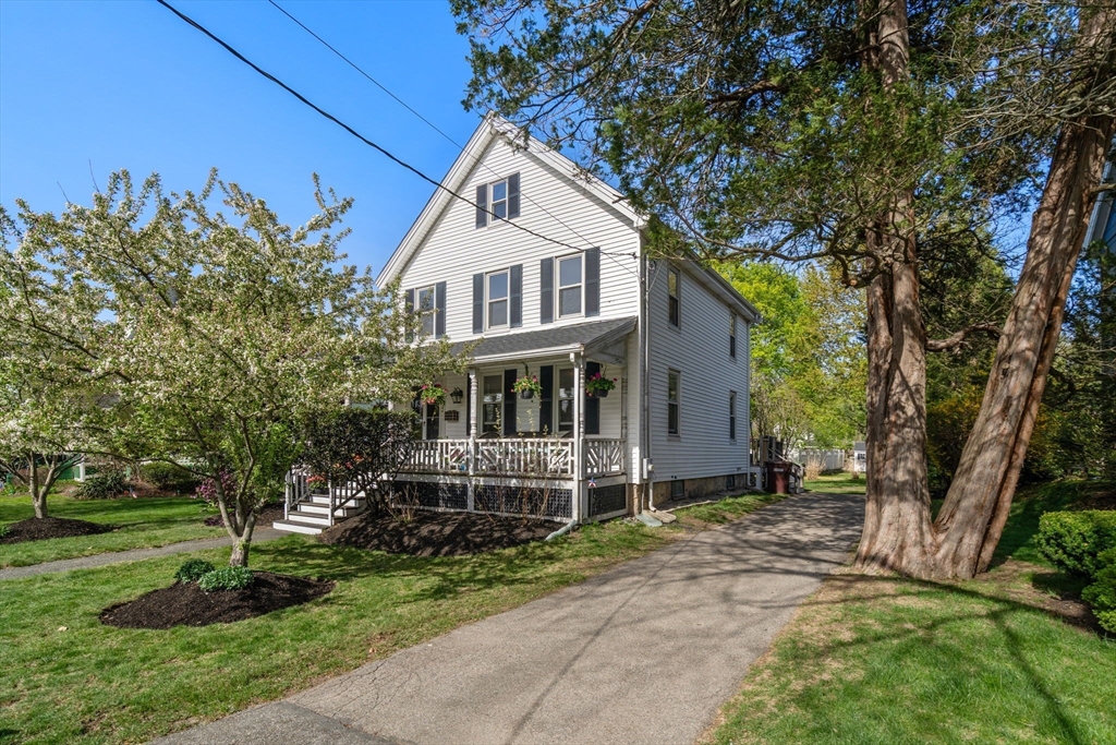 a front view of a house with a garden