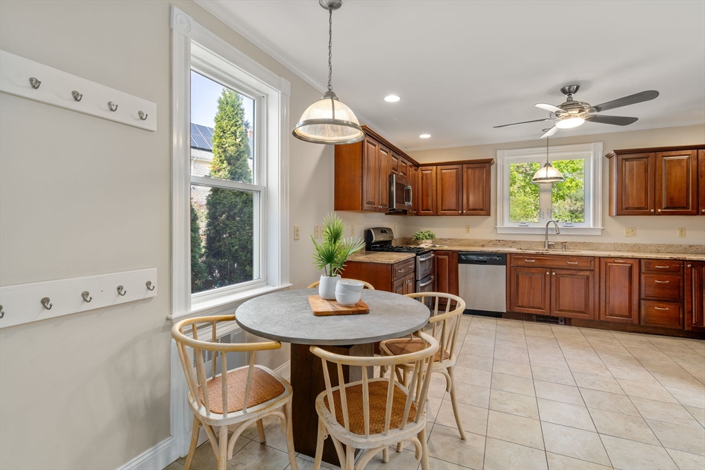 110 Mt Vernon Street Dedham, MA 02026 - Photo 14 of 35 a kitchen with a dining table chairs and white cabinets