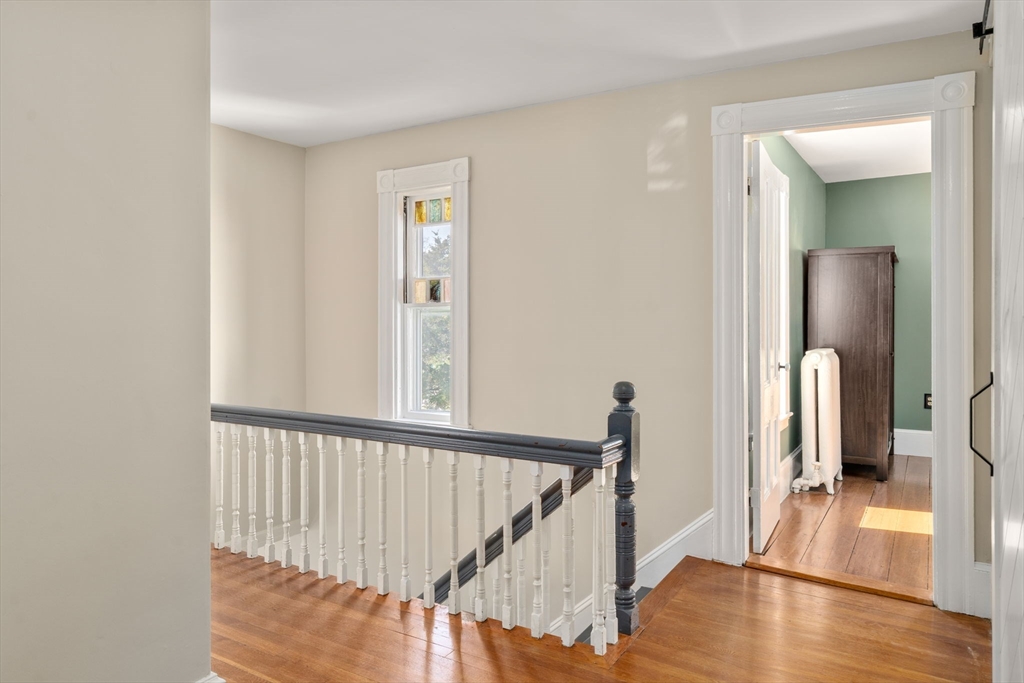 110 Mt Vernon Street Dedham, MA 02026 - Photo 18 of 35 a view of a hallway with wooden floor and stairs
