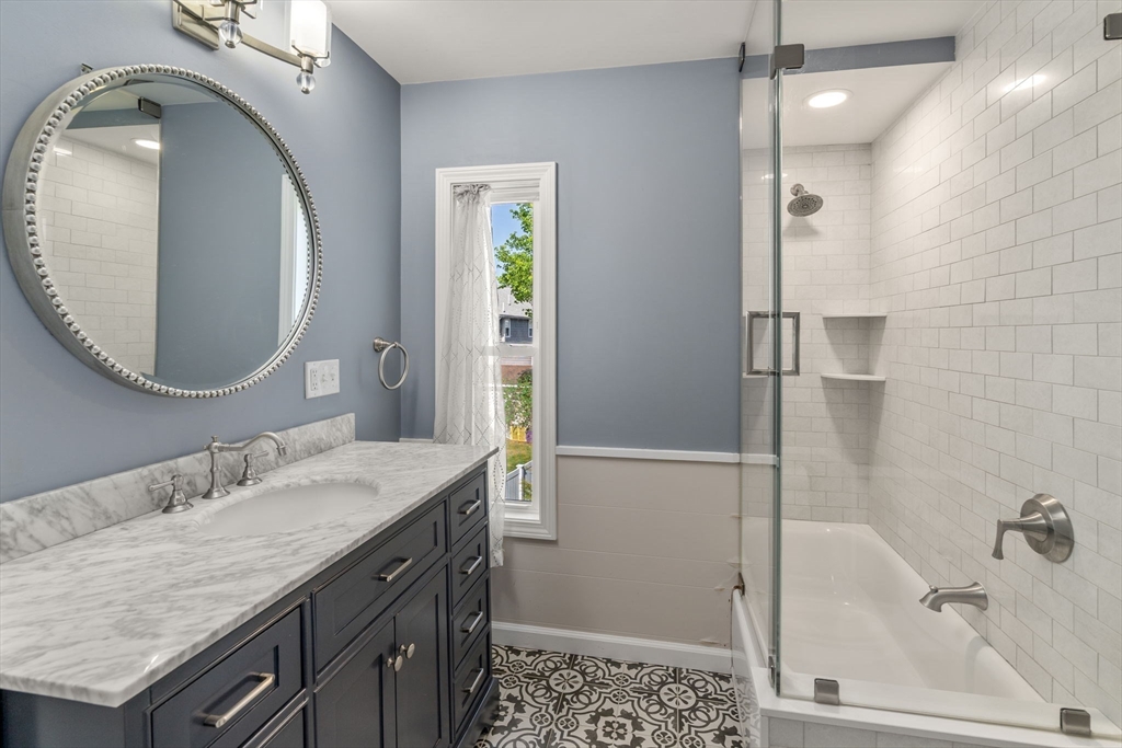 110 Mt Vernon Street Dedham, MA 02026 - Photo 21 of 35 a bathroom with a granite countertop bathtub shower sink and mirror