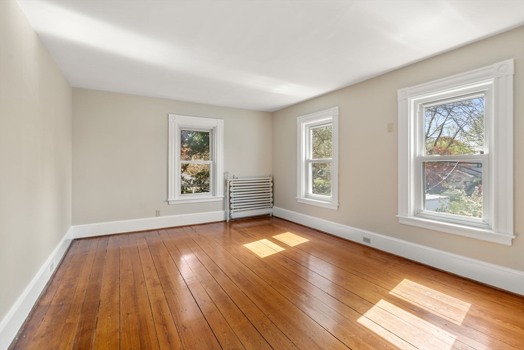 110 Mt Vernon Street Dedham, MA 02026 - Photo 22 of 35 a view of an empty room with wooden floor and a window