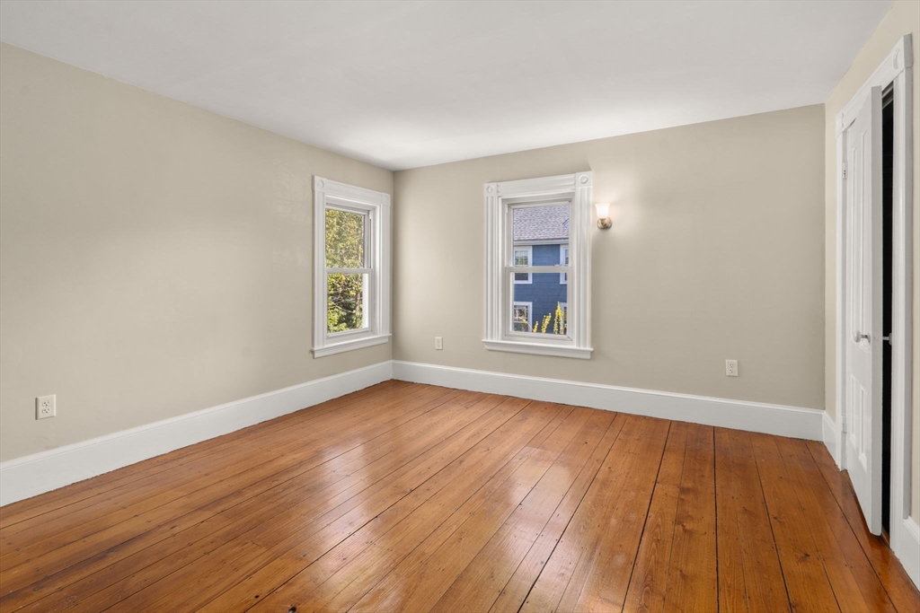 110 Mt Vernon Street Dedham, MA 02026 - Photo 25 of 35 a view of an empty room with wooden floor and a window