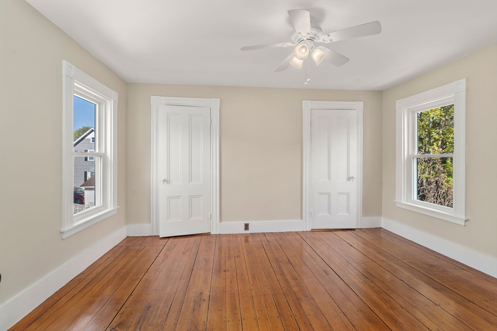 110 Mt Vernon Street Dedham, MA 02026 - Photo 26 of 35 a view of an empty room with window and wooden floor