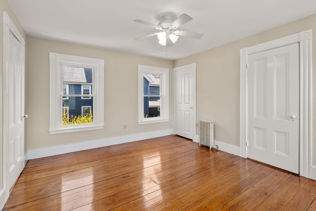 110 Mt Vernon Street Dedham, MA 02026 - Photo 27 of 35 a view of an empty room with window and wooden floor