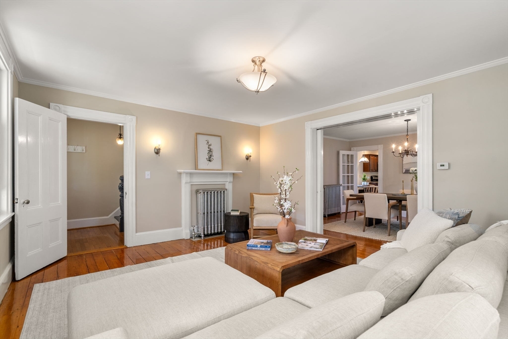 110 Mt Vernon Street Dedham, MA 02026 - Photo 8 of 35 a living room with furniture a fireplace and a chandelier