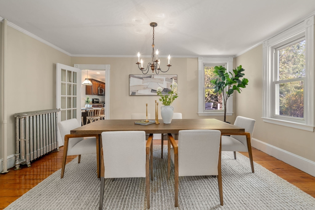 110 Mt Vernon Street Dedham, MA 02026 - Photo 9 of 35 a dining room with chandelier and wooden floor
