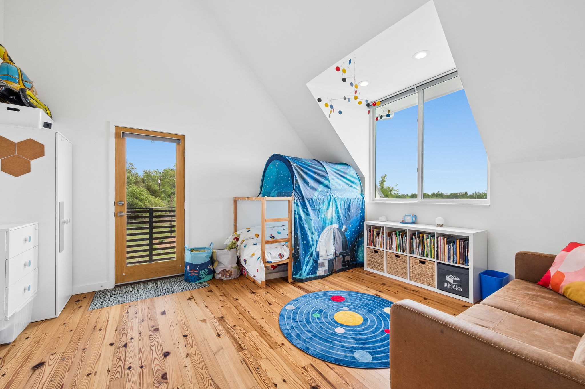 534 Old McDade Road Elgin, TX 78621 - Photo 26 of 40 Second bedroom has a screened Juliet balcony that opens to let the breeze flow through the second story. Second bedroom has a built-in dresser and shelves, as well as an ensuite bathroom.