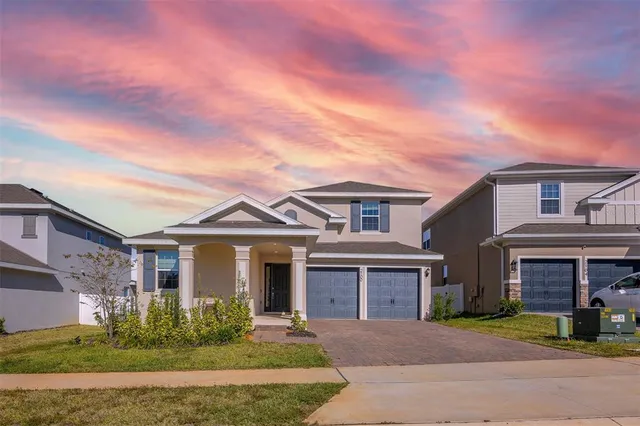 front view of a brick house with a yard