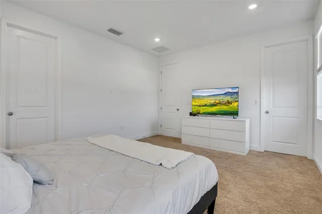 a bedroom with a bed and a dresser