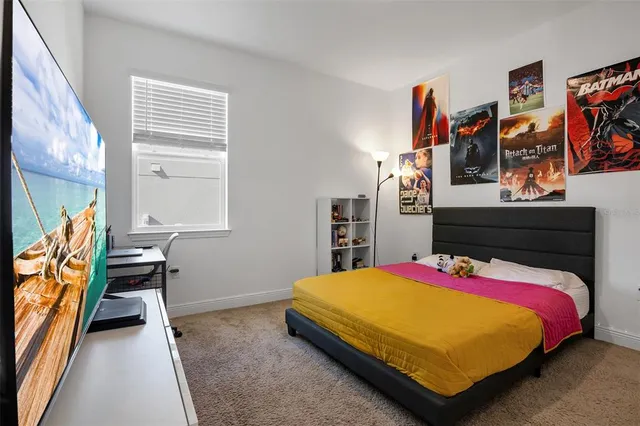 a bed sitting in a bedroom next to a window