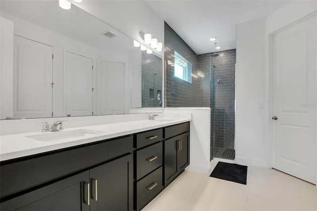 a bathroom with a double vanity sink and a mirror