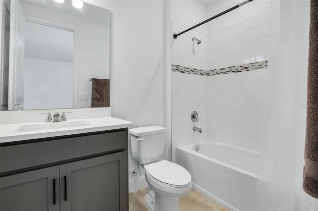 a bathroom with a sink toilet tub and shower
