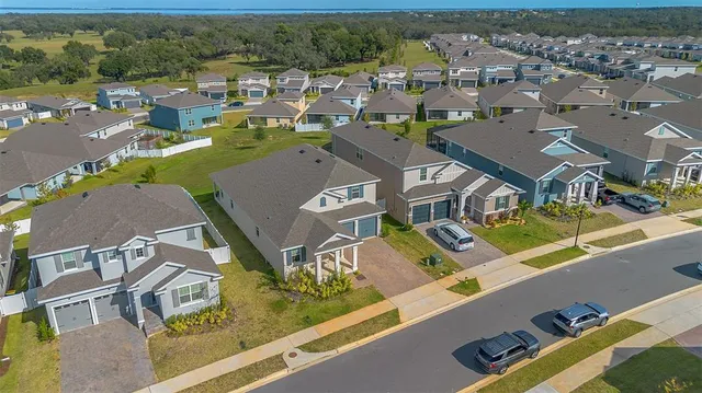 an aerial view of residential houses with outdoor space