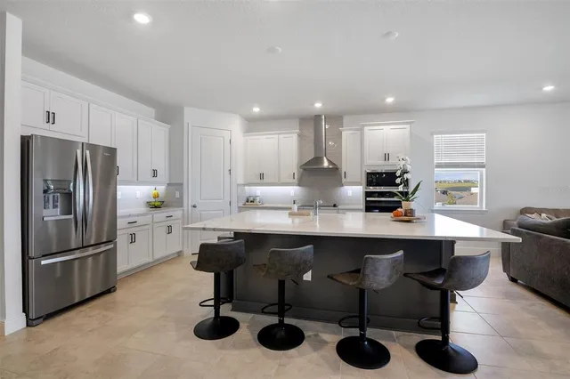 a kitchen with stainless steel appliances granite countertop a sink and refrigerator
