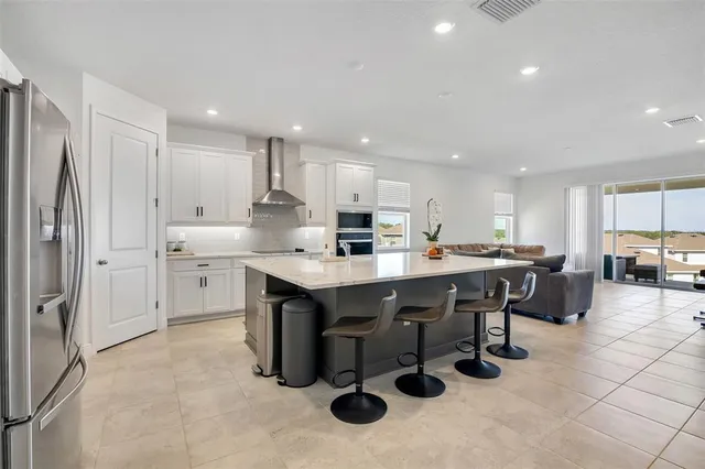 a kitchen with stainless steel appliances granite countertop a sink counter space and cabinets