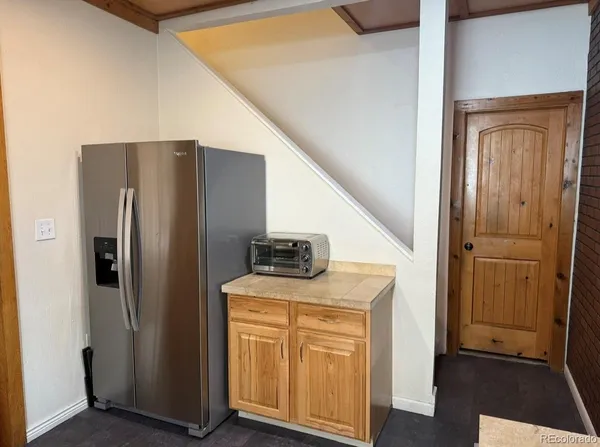 a view of a hallway with wooden floor and closet