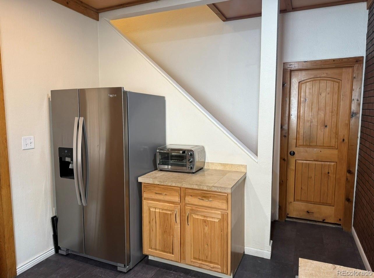 4353 Kalamath Street Denver, CO 80211 - Photo 11 of 28 a kitchen with stainless steel appliances granite countertop a refrigerator and a sink