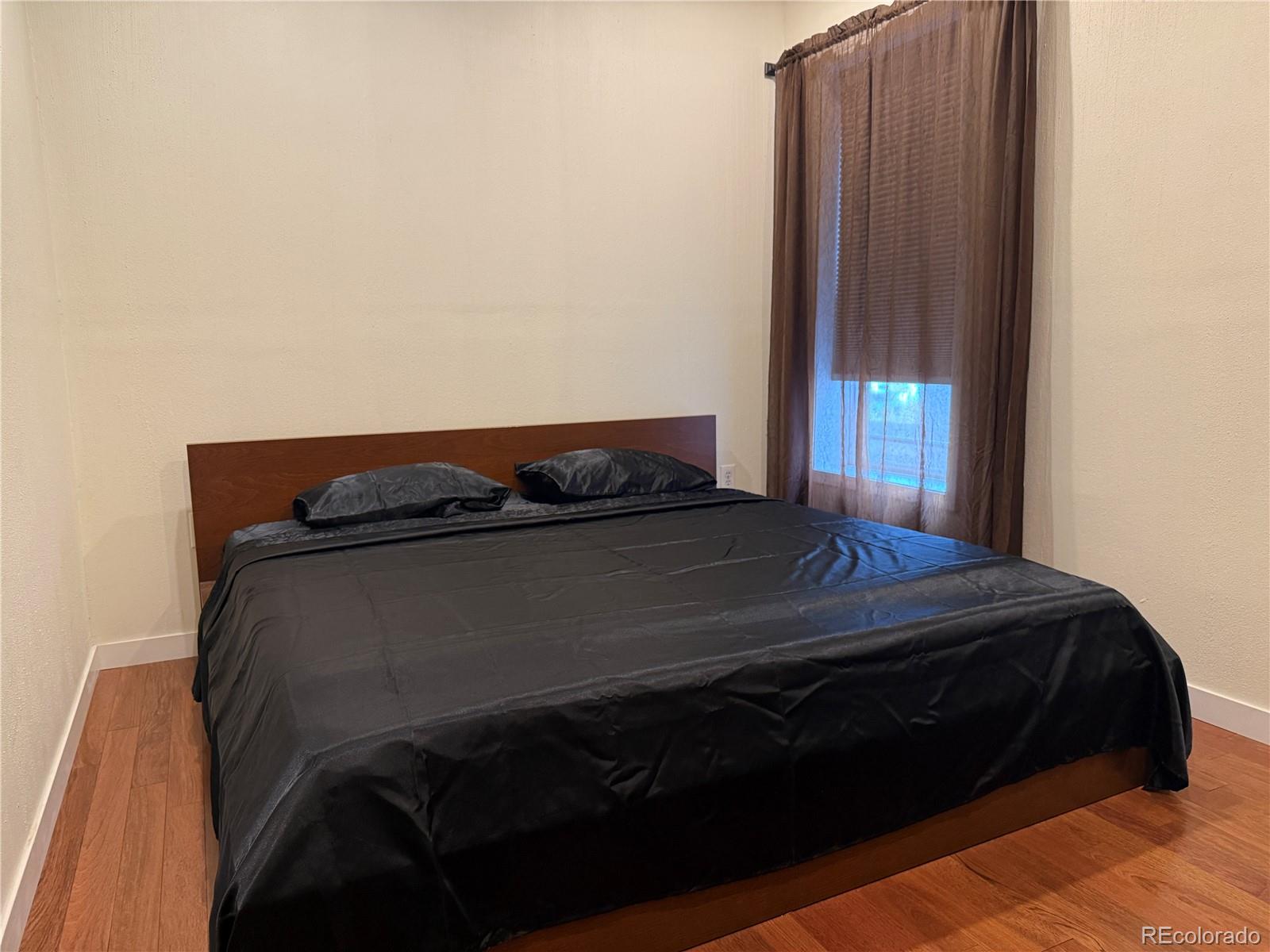 4353 Kalamath Street Denver, CO 80211 - Photo 16 of 28 a bedroom with a bed and window
