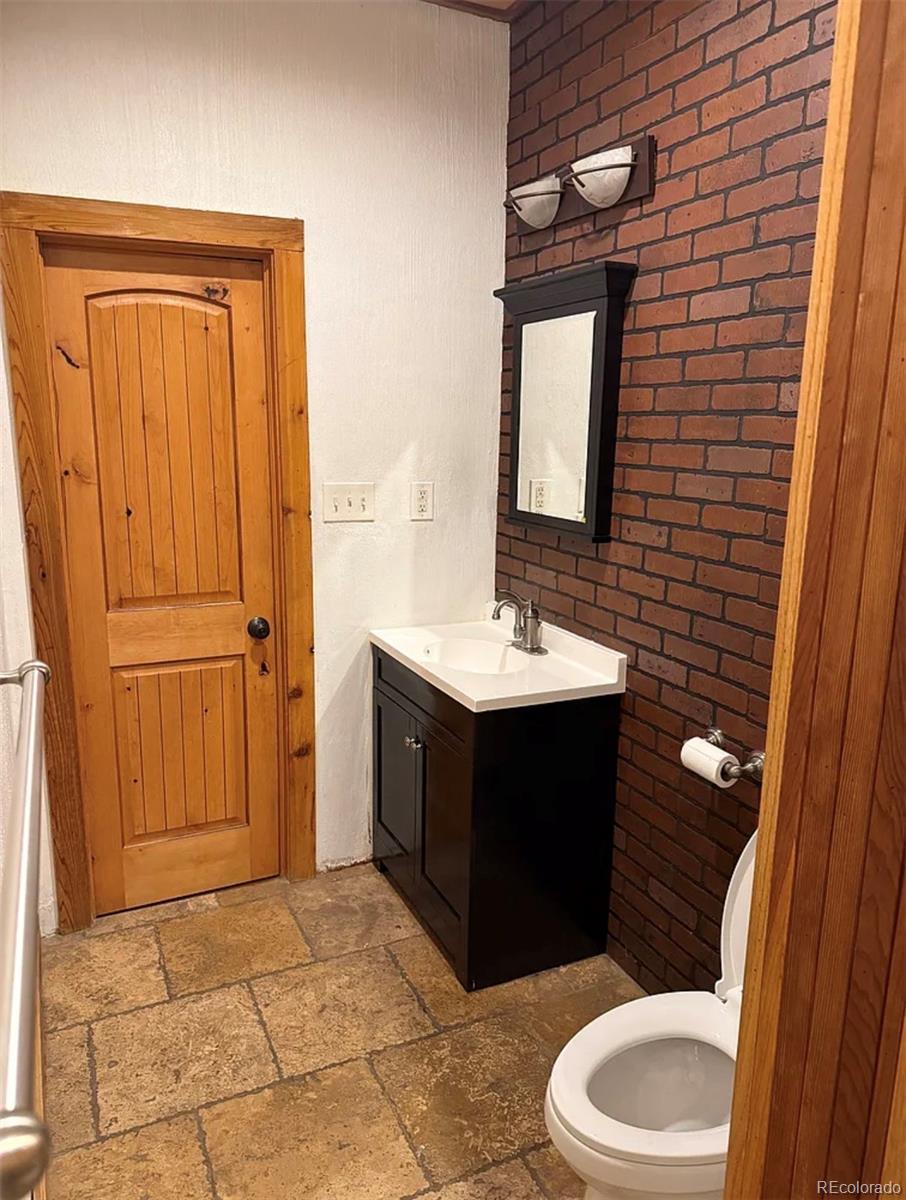 4353 Kalamath Street Denver, CO 80211 - Photo 19 of 28 a bathroom with a sink vanity mirror and toilet