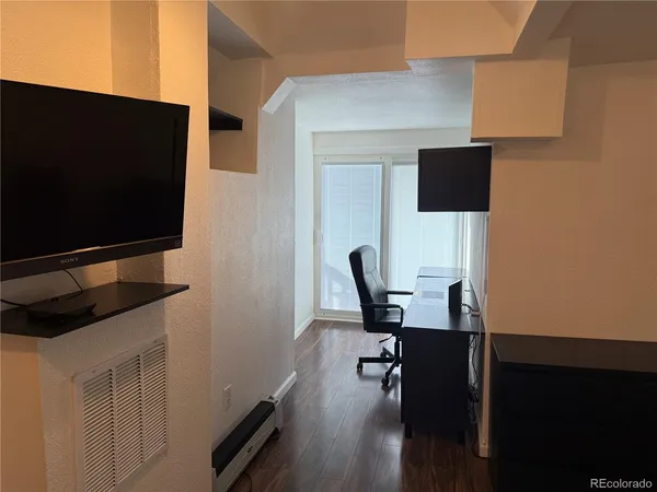 a bedroom with a bed and a flat screen tv