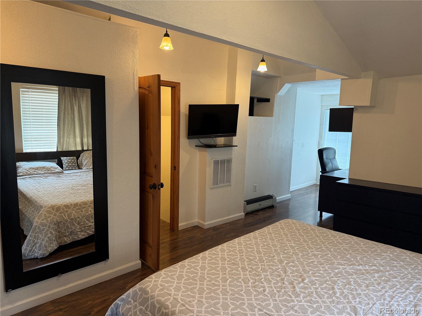 4353 Kalamath Street Denver, CO 80211 - Photo 23 of 28 a bedroom with a bed and a flat screen tv