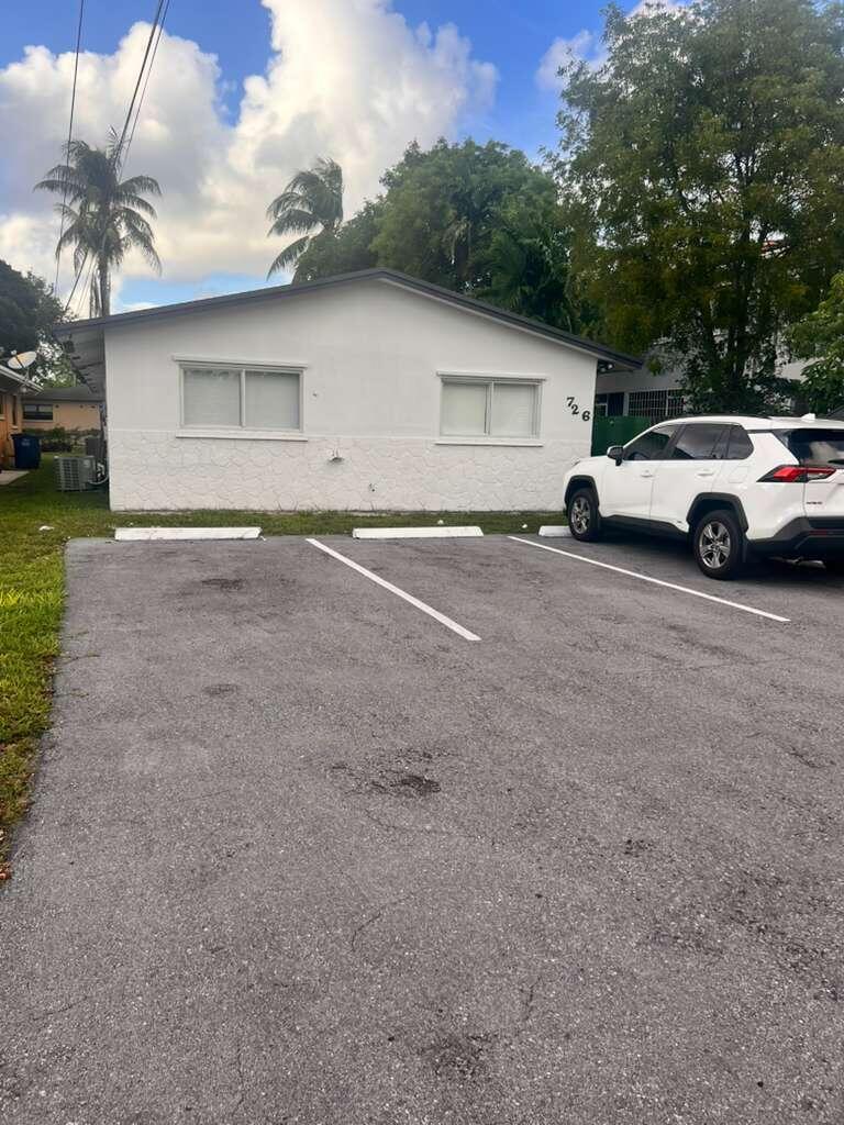 726 Southwest 7th Street, Unit 12 Hallandale Beach, FL 33009 - Photo 2 of 5 a view of a car parked in front of house