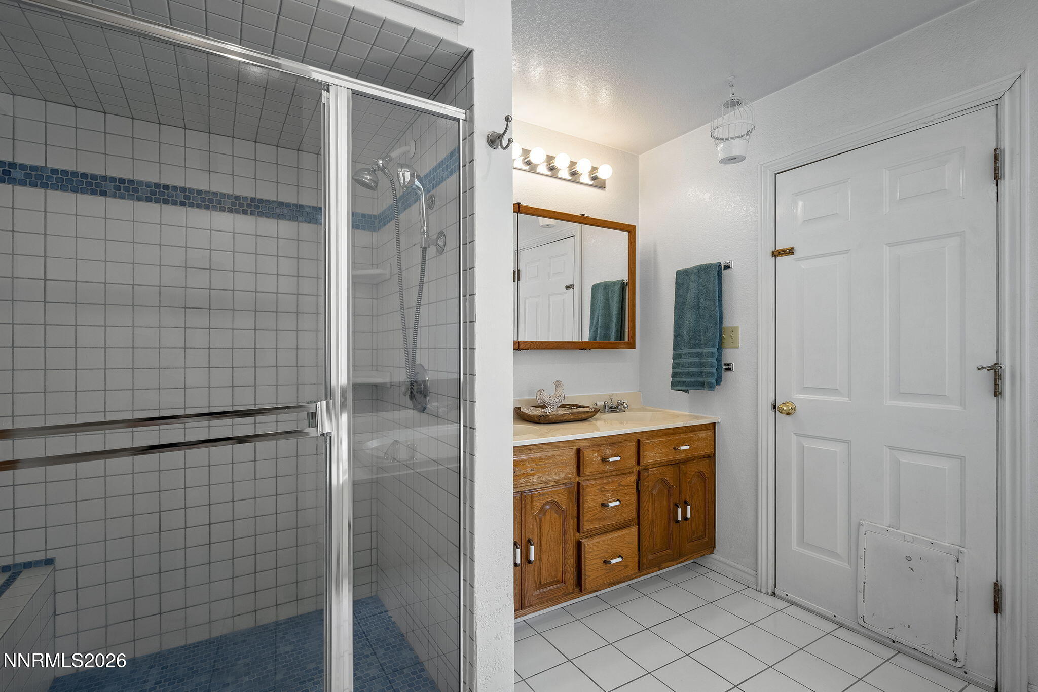 2985 Socrates Drive Reno, NV 89512 - Photo 12 of 52 a bathroom with a shower sink and mirror