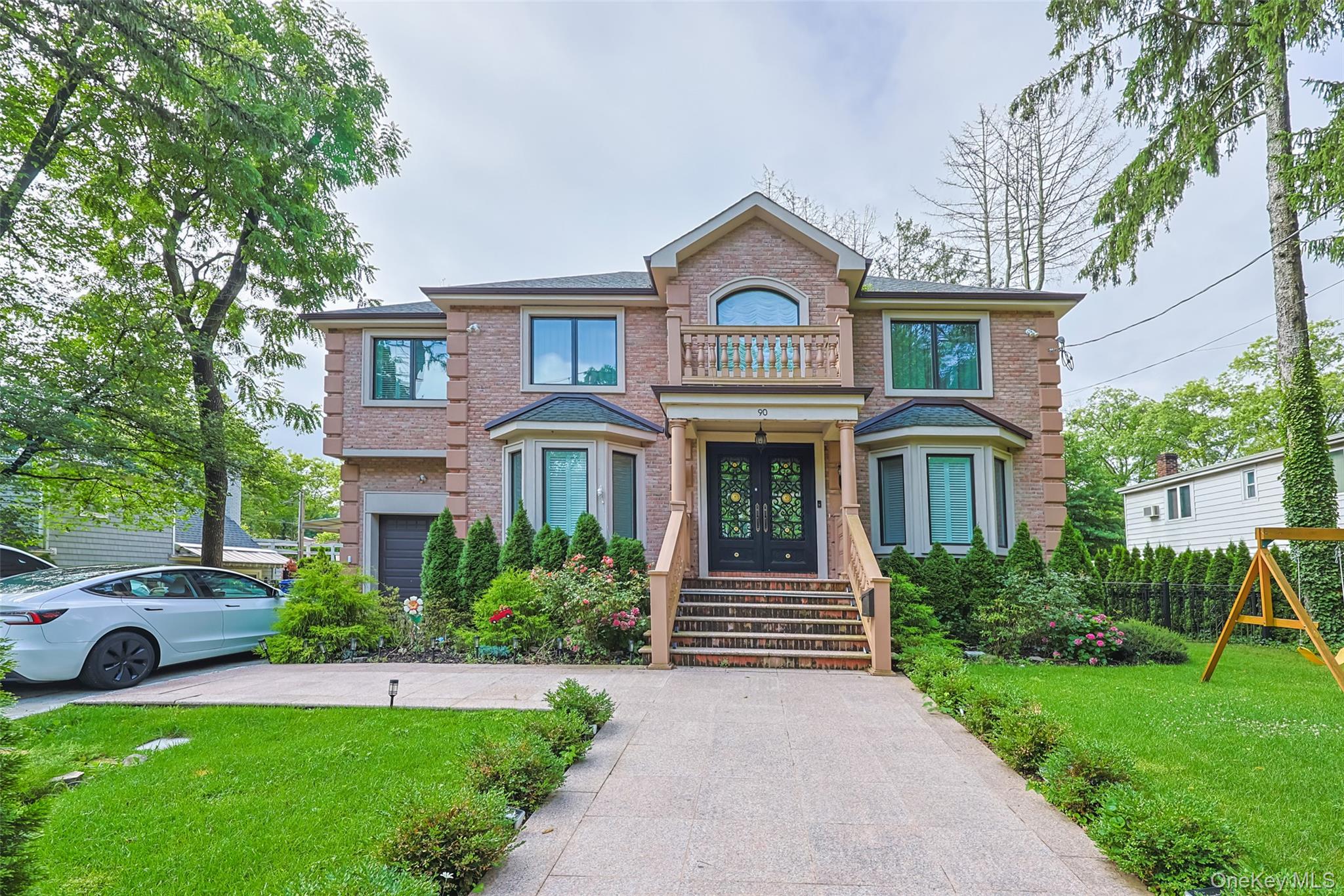 a front view of a house with garden