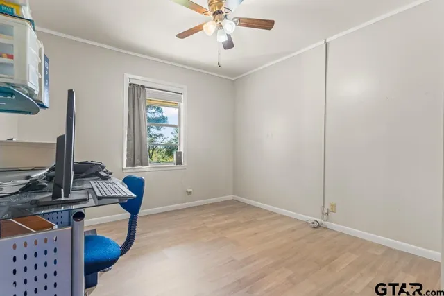 a view of room with window and ceiling fan